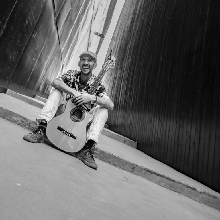 Renny Jackson album cover. Musician Manuel Rodriguez with guitar. Poetry to Music project promo image.